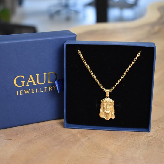 Gouden Jezus-hanger in een blauwe GAUD JEWELLERY cadeaubox.