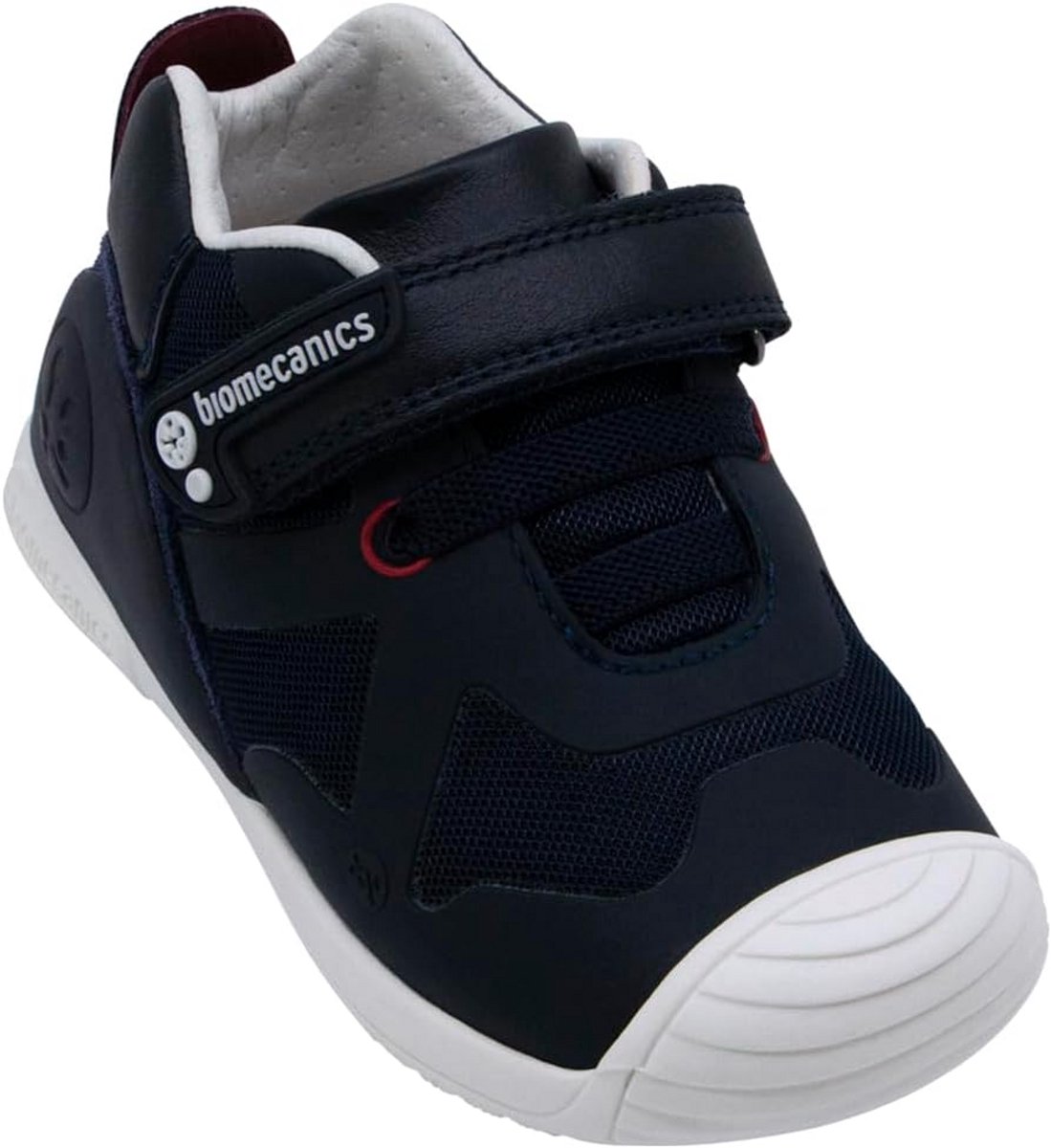 Sportieve roze leren kinderschoenen met klittenbandsluiting, elastiek en versterkte ronde teenkap voor extra duurzaamheid.