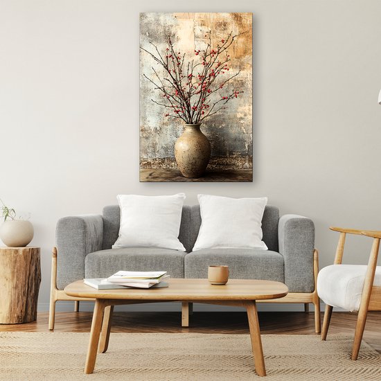 Canvas print van takken met rode besjes in een vaas, tegen een rustieke muur, boven een grijze bank.