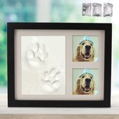 Een zwart fotolijst met pootafdrukken van een hond en twee foto's van een hond met een feestmuts.