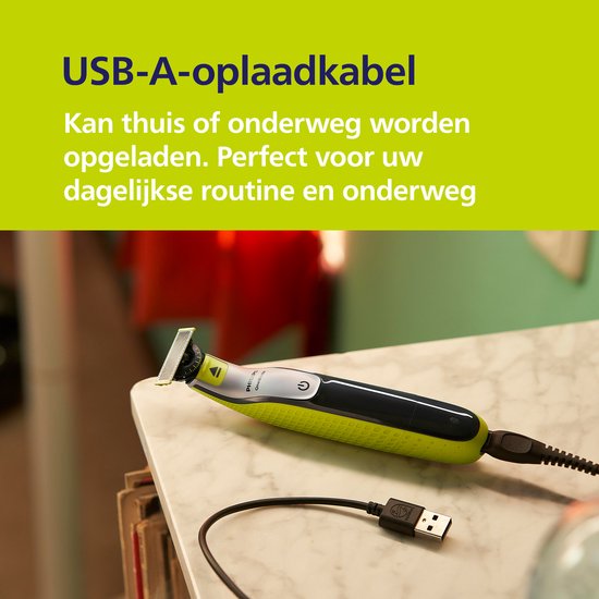 Gele en zwarte OneBlade trimmer met USB-A oplaadkabel op marmeren oppervlak.