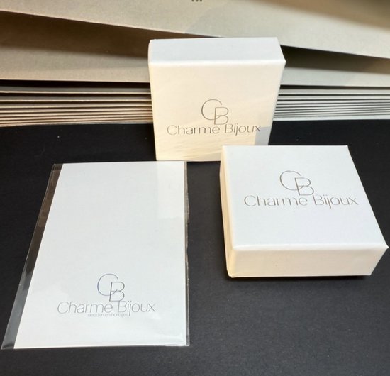 Witte dozen en verpakking met 'Charme Bijoux' logo.