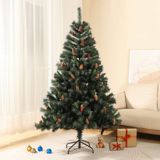 Kunstkerstboom van 180 cm met dennenappels en bessen in een interieur, naast kerstcadeaus en een speelgoedbeer.