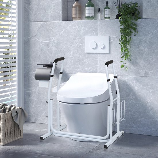 Wit toiletframe met beugels, opbergmand en toiletpapierhouder naast een toilet.