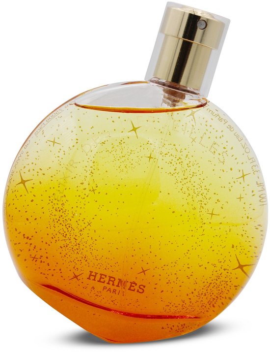 Oranje parfumfles met gouden dop, versierd met glinsterende sterren en stipjes.