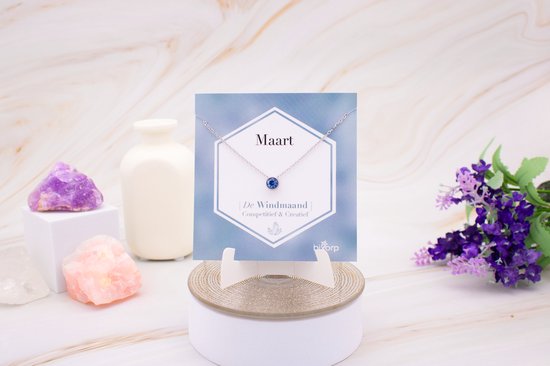 Collier argenté avec pendentif en zircone bleue sur carte, 'Maart' Le Mois du Vent, Compétitif & Créatif, avec décoration.