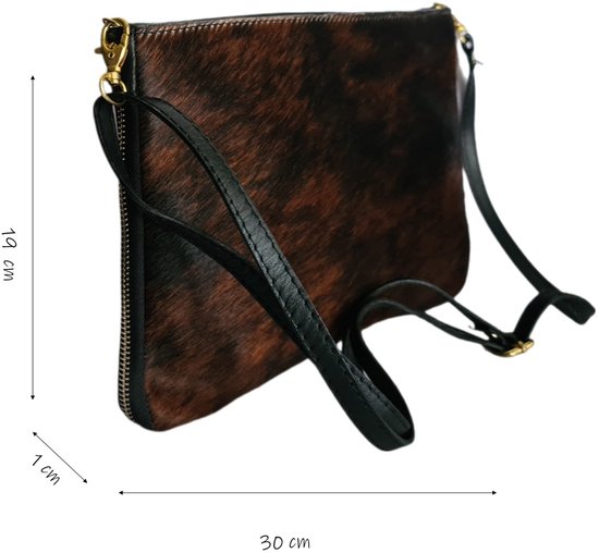 Bruine en zwarte koeienhuid clutch met zwarte leren bandjes. Afmetingen: 19x30x1 cm.