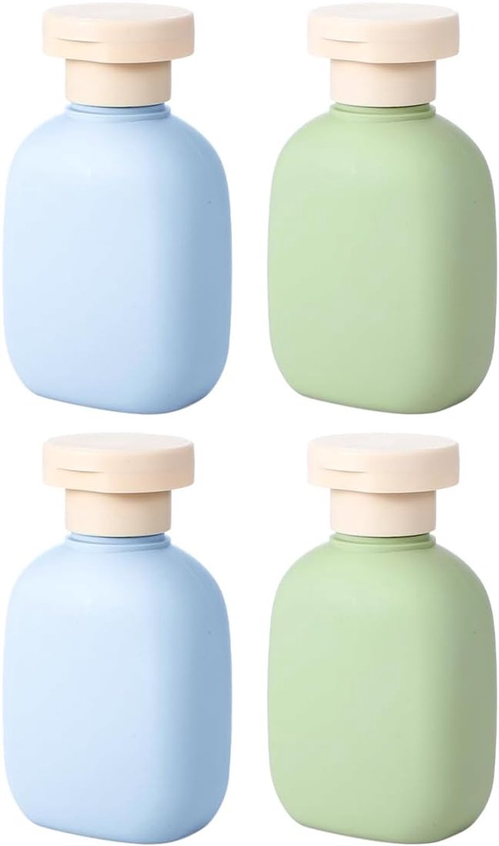 Verpakking van 4 knijpflesjes voor op reis. Navulbare plastic verpakkingen van 100 ml. Lege flessen met flip-top. Reisaccessoires voor shampoo, crèmes, lotion en conditioner.