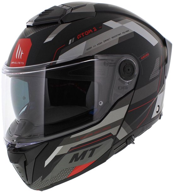 Zwarte systeemhelm met helder vizier, rood MT-logo en geometrische patronen in grijs en rood.