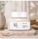 Beauty of Joseon Ground Rice and Honey Glow Mask in een potje, op een stenen onderzetter, met rijst en tarwe op de achtergrond.