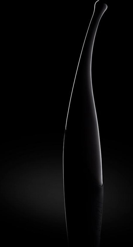 Silhouet van een gebogen zwarte vibrator met een lichte gloed.