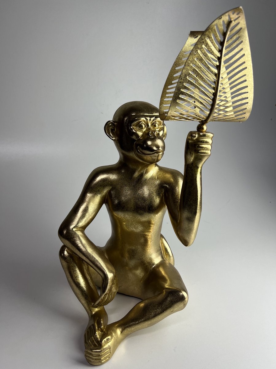 Grote metalen gouden aap met blad