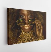 Close-up of magic golden african american female model in massive sunglasses with bright glitter makeup, glossy hairstyle and big red lips posing on the studio background - Modern