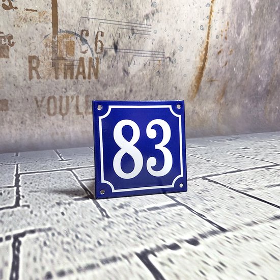 Blauw huisnummer 83 met witte cijfers, geplaatst op een tegelvloer tegen een decoratieve achtergrond.