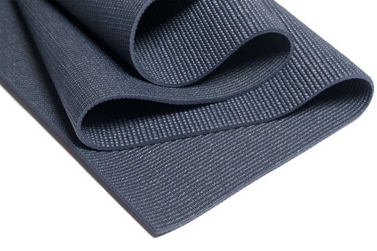 Gedetailleerd beeld van de textuur van een donkerblauwe yogamat met een subtiel ribbelpatroon.