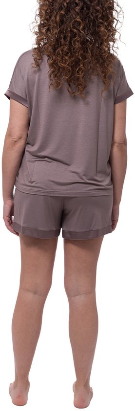 Model van achteren gezien in een taupe pyjamaset: losvallend T-shirt met korte mouwen en loszittende shorts.