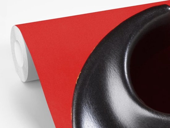 Cendrier Yin et Yang devant un fond d' fotobehang rouge
