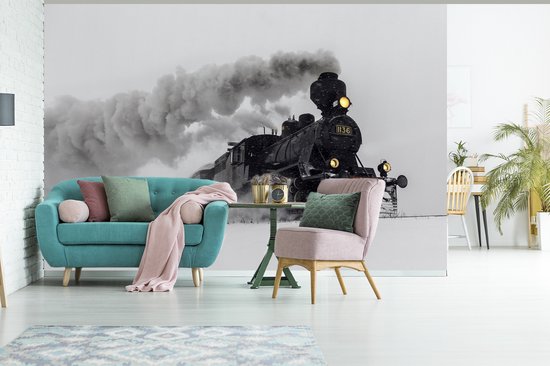 Behang - Fotobehang Stoomlocomotief in de sneeuw - liggend - Breedte 420 cm x hoogte 280 cm
