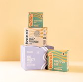 Wondr conditionerbar, scalp massager en shampoo bar XL in verpakkingen met groene en oranje accenten.
