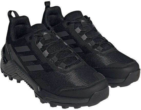 Zwarte lage wandelschoenen met donkergrijze accenten, het Terrex-logo en de drie Adidas-strepen.