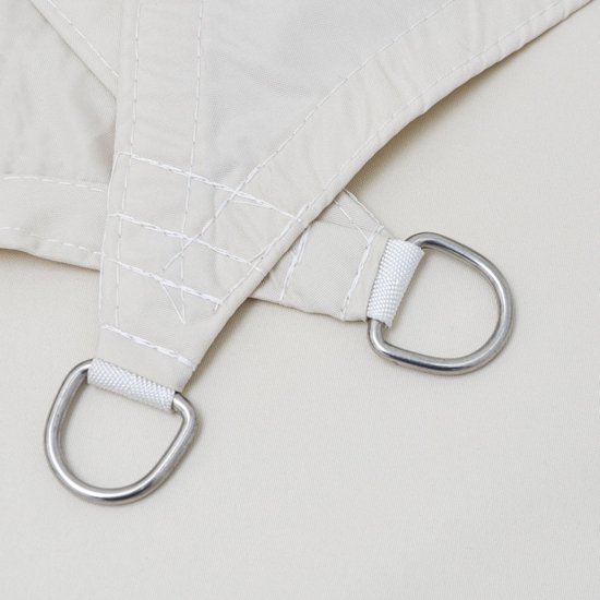 Detail van een beige schaduwdoek met metalen D-ringen en versterkte naden.