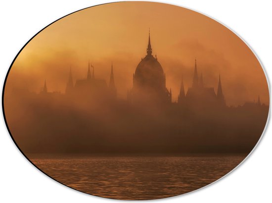 Dibond Ovaal - Foto van Hongaars Parlementsgebouw aan het Water met Mist Ervoor - 40x30 cm Foto op Ovaal (Met Ophangsysteem)