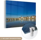 MuchoWow® Glasschilderij 120x80 cm - Schilderij acrylglas - Afbeelding van de Maas in Maastricht - Foto op glas - Schilderijen