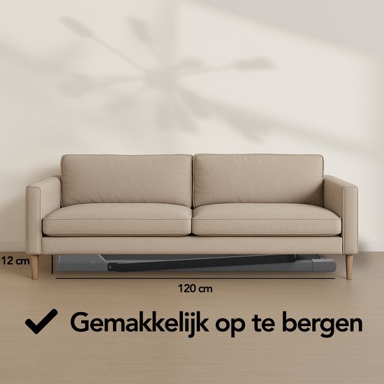 Grijze, opvouwbare loopband naast een bank, met de afmetingen 120 cm lang en 12 cm hoog.