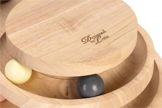 Close-up van de "Designed by Lotte"-logo op de houten speeltoren met gekleurde balletjes (wit, grijs, roze).