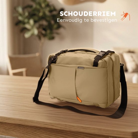 Zandkleurige tas met schouderband, als schoudertas gedragen op een houten tafel.