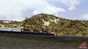 Gezicht op een bocht op een circuit met de tekst 'Circuit Park Zandvoort'.