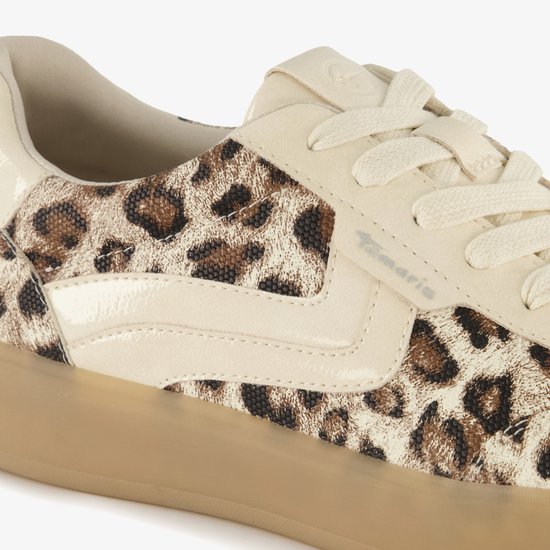 Detail van een beige Tamaris sneaker met panterprint stof, beige suède en lakleren accenten.