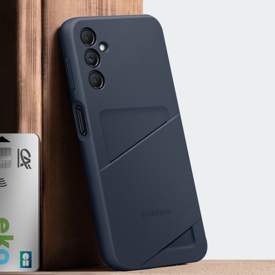 Donkerblauwe telefoonhoes met kaartvak, leunend tegen een houten object.