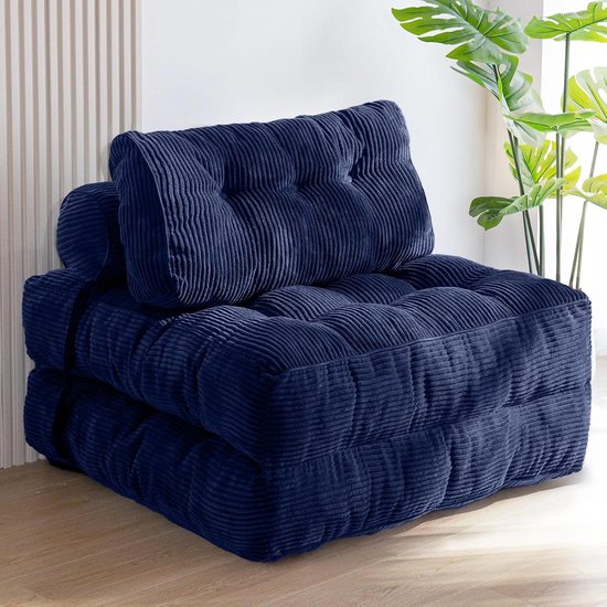 Donkerblauwe, gecapitonneerde fauteuil van corduroy in opgevouwen zitpositie.