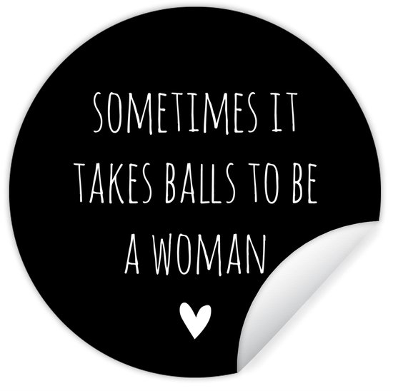 Cercle mural noir avec texte blanc "SOMETIMES IT TAKES BALLS TO BE A WOMAN" et un cœur.