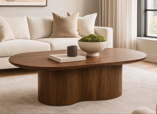 Ovale salontafel van walnoothout met een brede poot, met daarop een kom met mos en een boek.