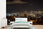 Behang - Fotobehang De skyline van Medellin in de avond in het Zuid-Amerikaanse Colombia - Breedte 450 cm x hoogte 300 cm