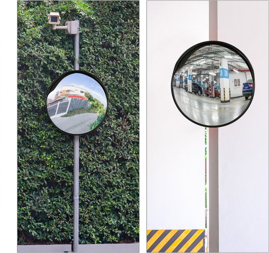Miroir convexe monté sur un poteau dans une haie verte, avec une caméra de surveillance au-dessus. Reflet d'une maison.