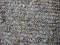 Textuur van beige en bruine lusjes in een trapmat.