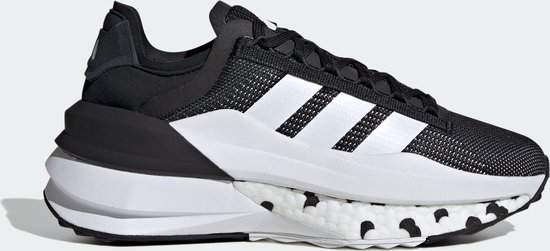 Vue latérale d'une chaussure de sport noire avec bandes Adidas blanches, semelle blanche à pois noirs.