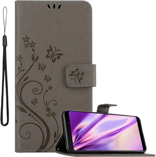 Étui de téléphone gris à motif floral, avec dragonne, ouvert avec un smartphone en mode paysage.