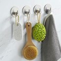 Zilverkleurige haakjes met een ronde schijfbevestiging, drie met een loofah en een met een handdoek.