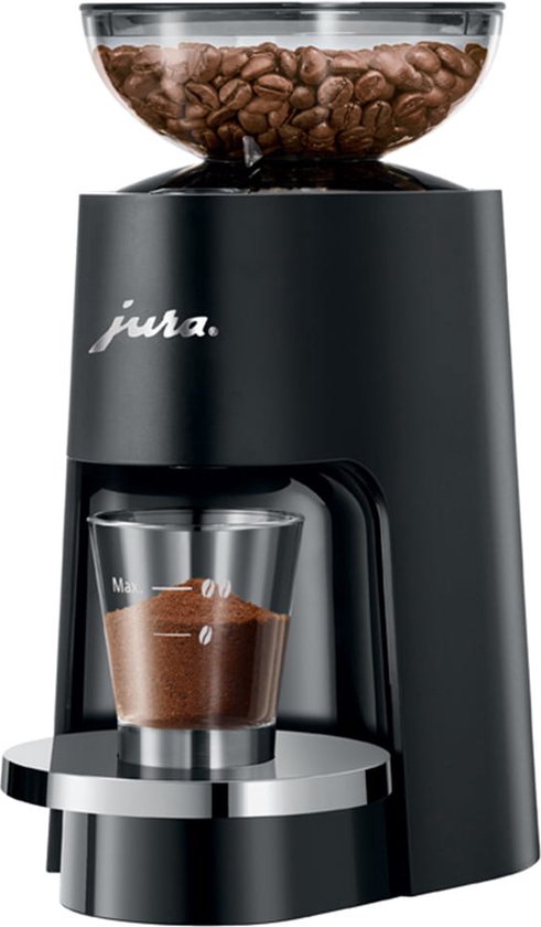 Zwarte Jura koffiemolen met transparante container vol koffiebonen en gemalen koffie in een glazen kopje.