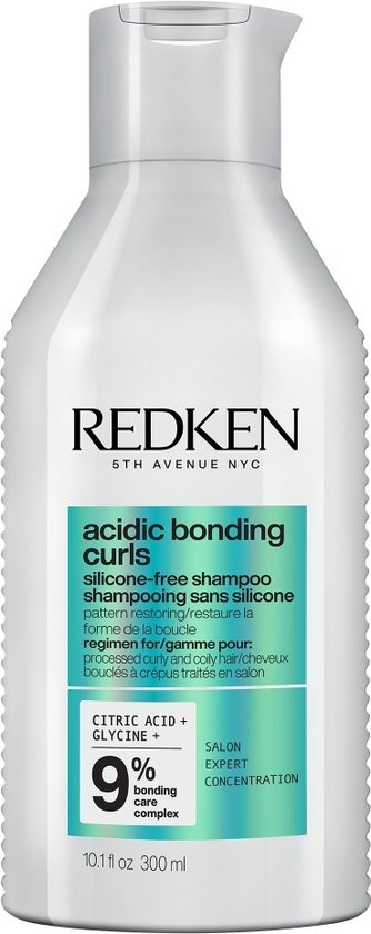 Shampoing Redken Acidic Bonding Curls dans une bouteille blanche avec texte bleu et vert. Contient Acide Citrique + Glycine.