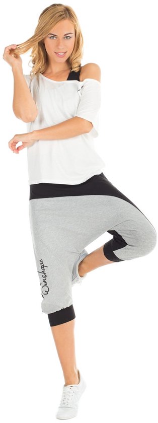 Model in balans, draagt wit off-shoulder t-shirt met 'Winshape' logo en grijze/zwarte capri broek.