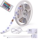 Een rol met een rgb led-strip, met afstandsbediening, adapter en connectoren.