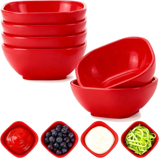 Coupelles rouges empilées, quatre individuellement avec du ketchup, des myrtilles, du yaourt et des courgettes râpées.