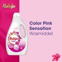 Bouteille rose de lessive Robijn Color Pink Sensation sur fond rose pâle avec texte violet.