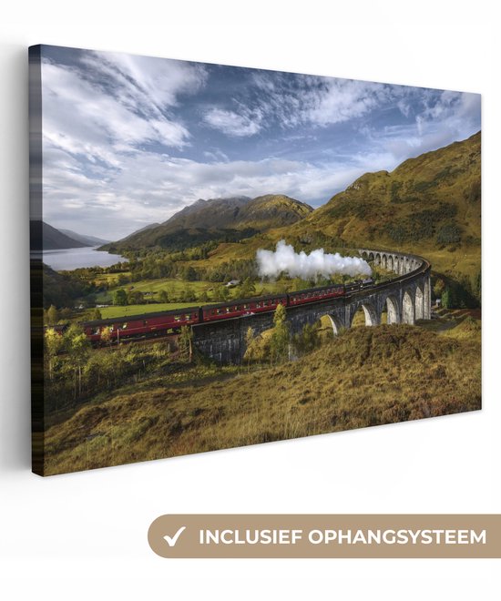 Canvas schilderij 60x40 cm - Wanddecoratie Een rode stoomlocomotief steekt een rivier over - Muurdecoratie woonkamer - Slaapkamer decoratie - Kamer accessoires - Schilderijen op canvas