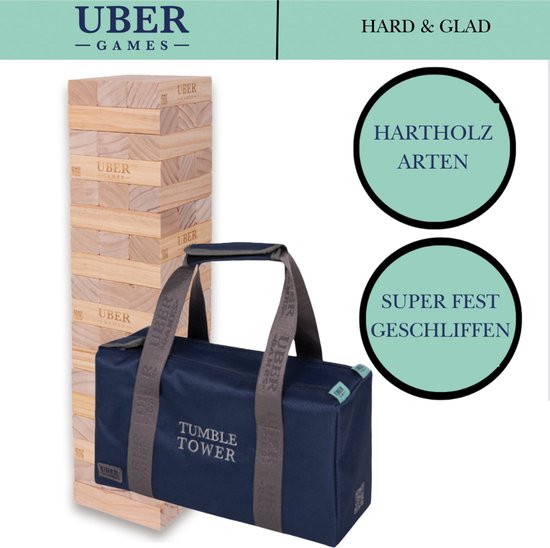 Houten stapeltoren en donkerblauwe draagtas met "TUMBLE TOWER" opdruk en "UBER GAMES" logo's. "HARTHOLZ ARTEN" en "SUPER FEST GESCHLIFFEN" cirkels ernaast.